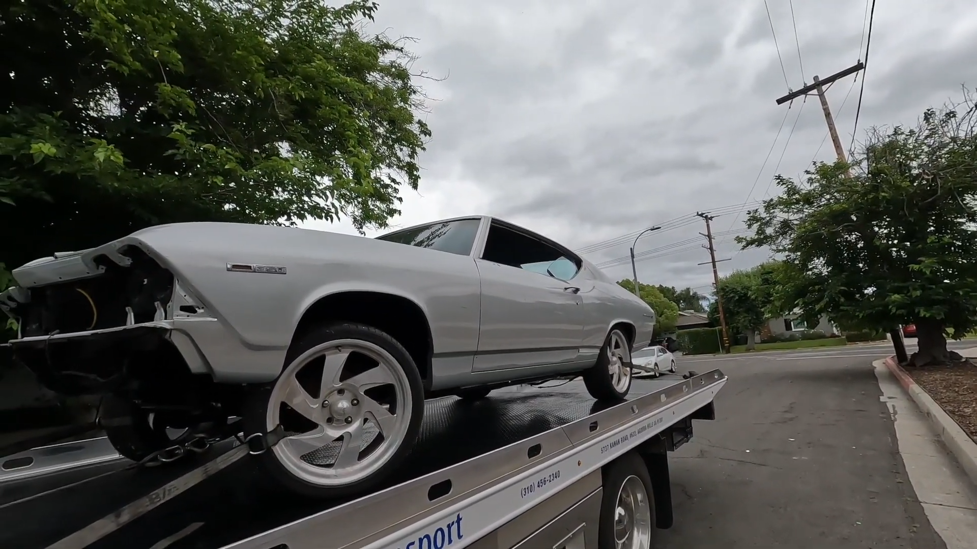 A silver Chevrolet Chevelle Malibu barn find on a tow truck 