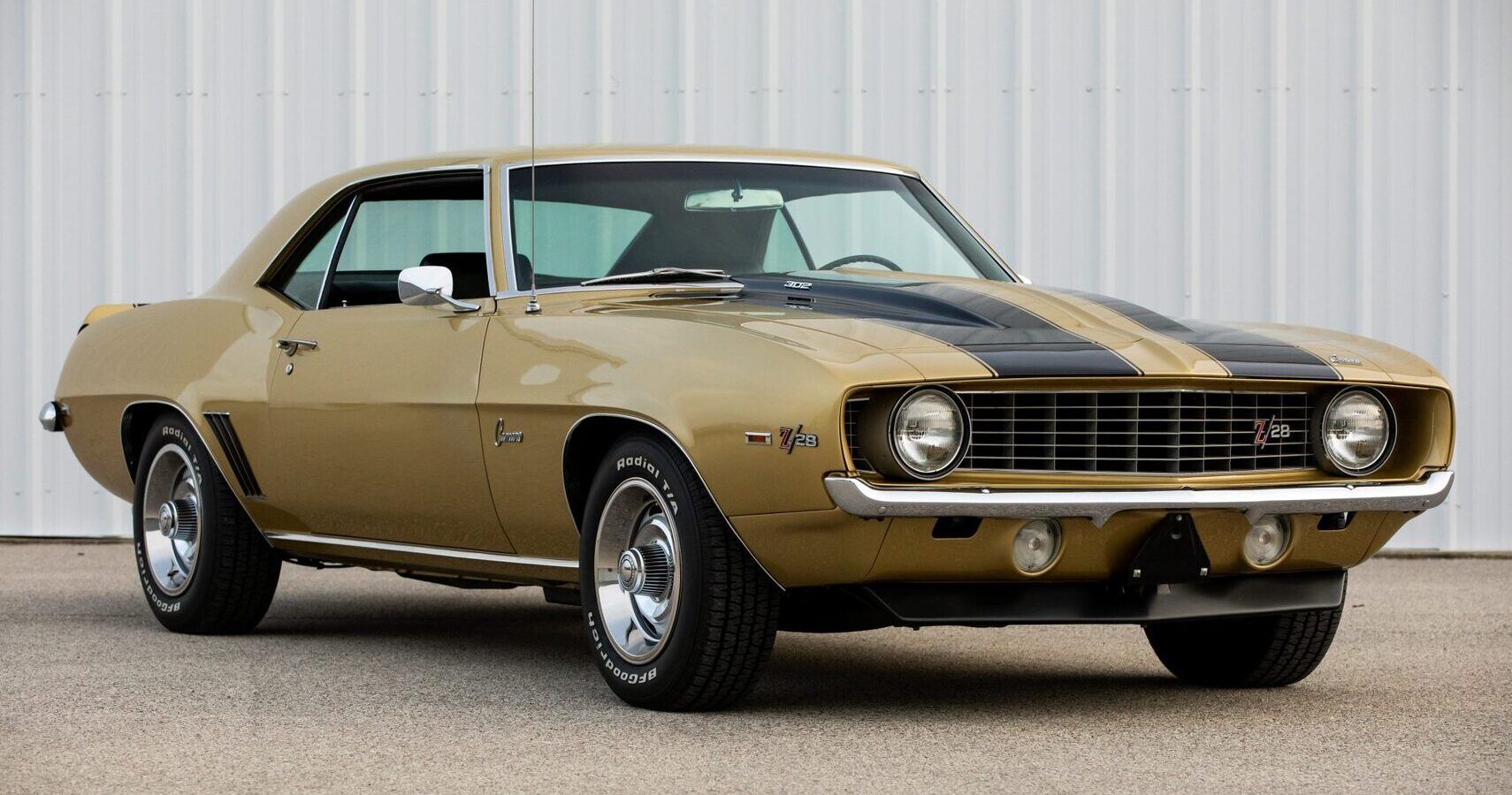 A gold 1969 Chevrolet Camaro Z/28 parked